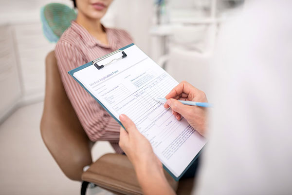 patient and dentist going over patient forms