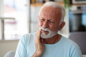 older man with mouth pain looking for an emergency dentist in Jupiter, FL